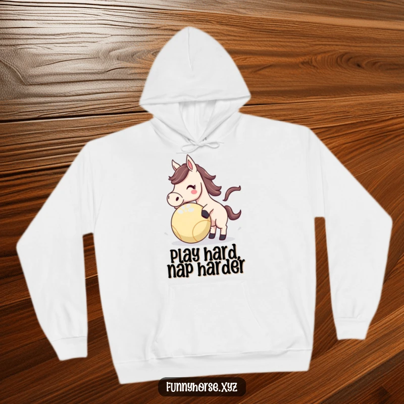 Funny Horse Hoodie featuring an energetic horse playfully nudging a bouncing ball, designed for cozy, humorous wear.